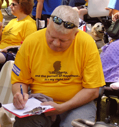 man signing petition